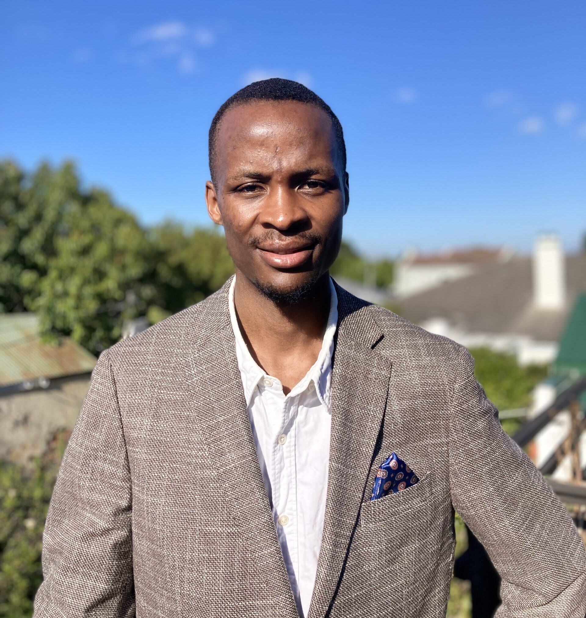 Gerald Khumalo, a digital marketing expert a smart blazer outdoors.